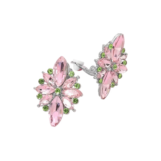 Pair of pink and green earrings on a pink background