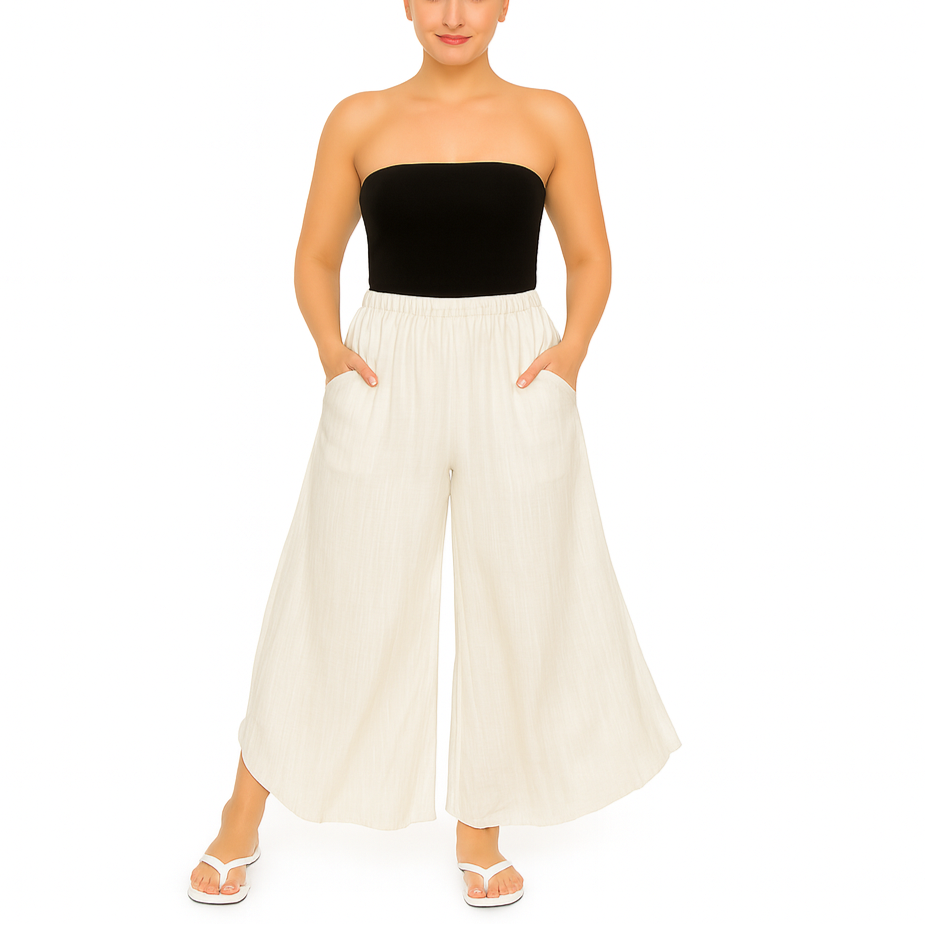 Woman wearing a black strapless top and white wide-leg pants on a white background