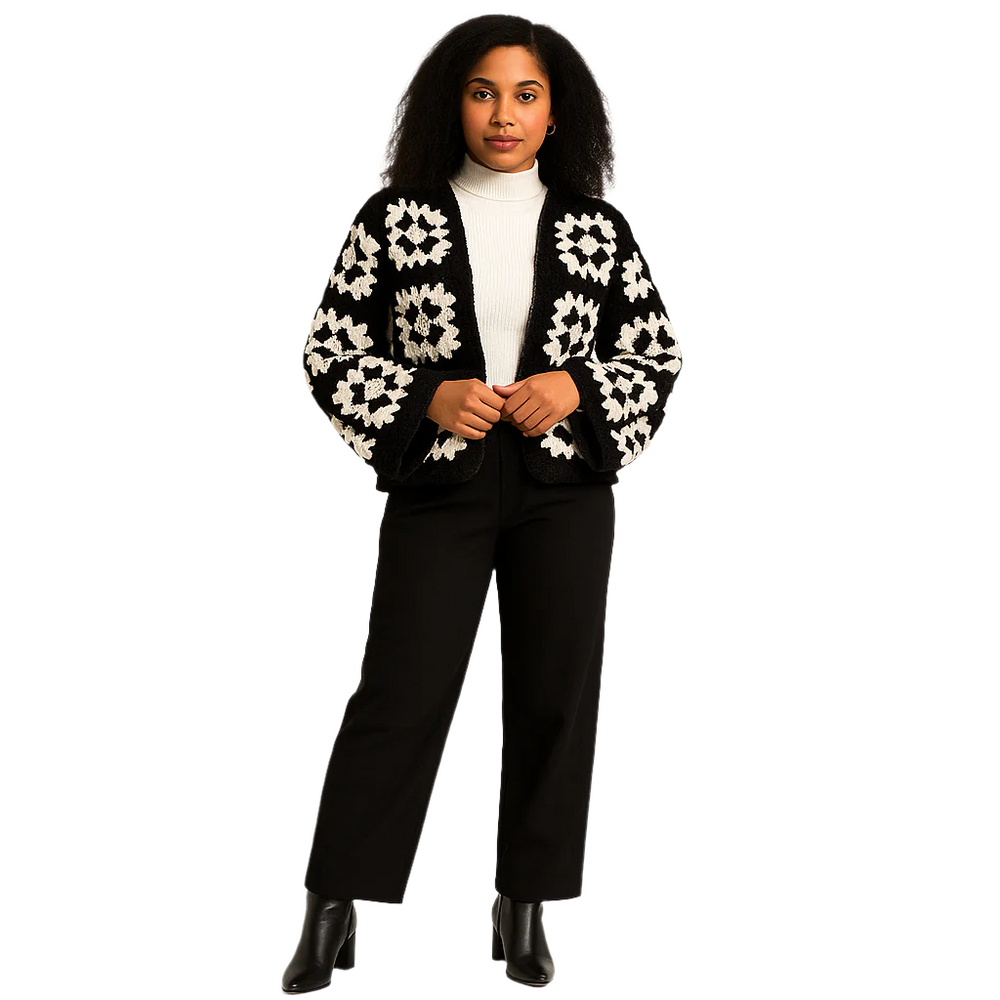 Woman wearing a black and white patterned cardigan on a white background