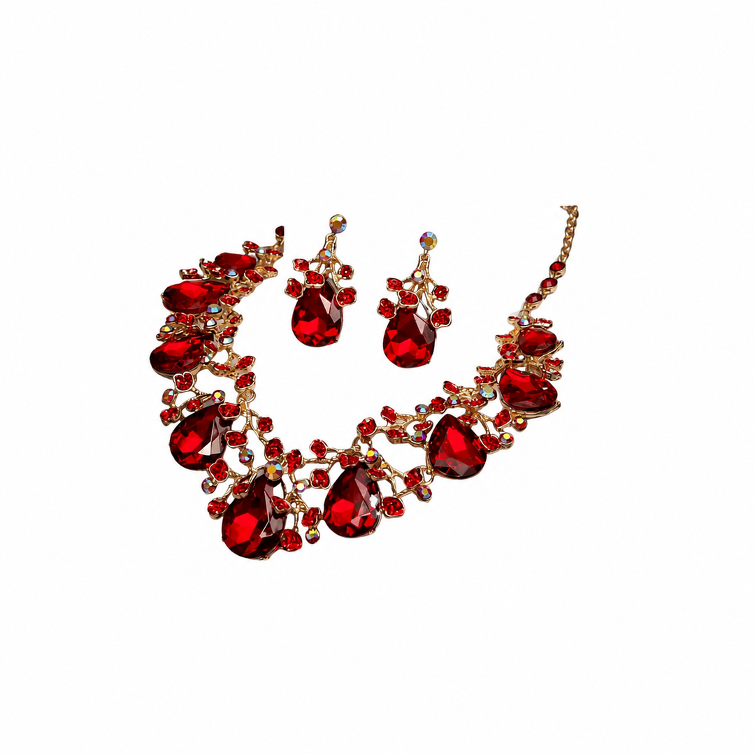 A red crystal jewelry set featuring a statement bib necklace and matching drop earrings, embellished with gold-toned metal and clear rhinestones, shown on a plain white background.
