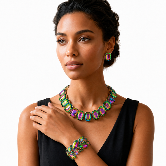 A woman wearing a matching multicolor gemstone jewelry set, including a statement necklace, matching drop earrings, and a bracelet, styled with a black sleeveless top against a solid white background.