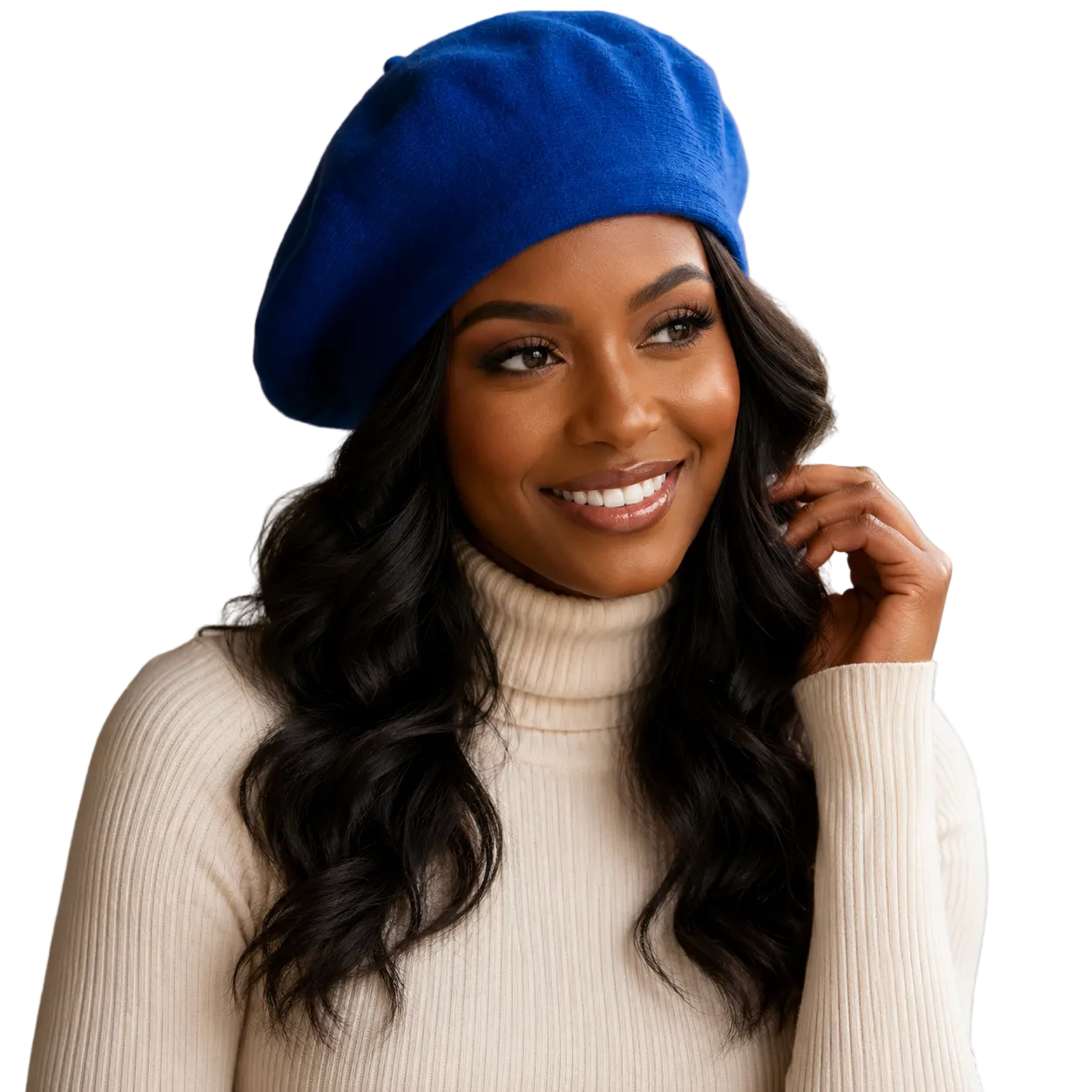 A smiling woman with long wavy black hair wears a bright royal blue beret and a cream ribbed turtleneck sweater against a warm beige studio background.