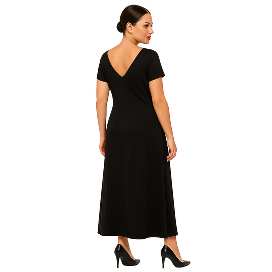 Woman wearing a black dress with a plain white background