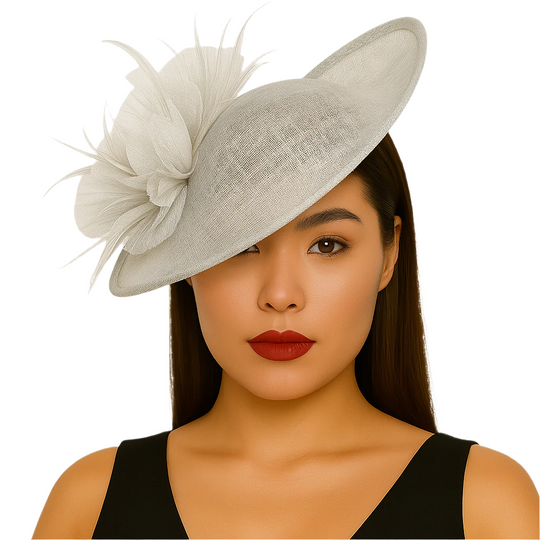 Woman wearing a gray decorative hat with a white feather against a plain background