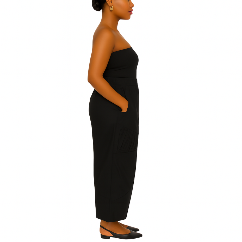 Woman wearing a black strapless dress on a white background
