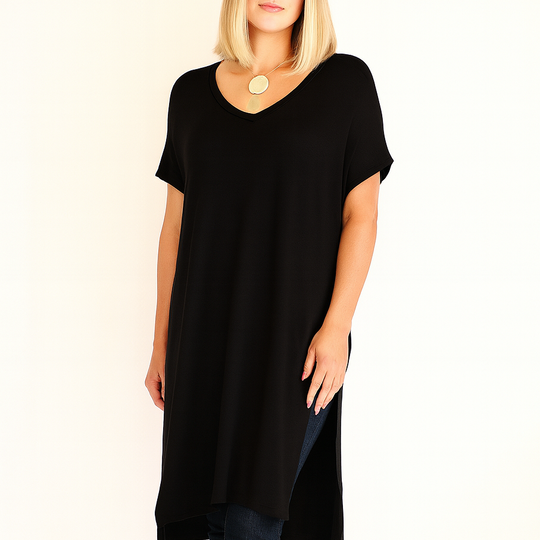 Woman wearing a black tunic and pants on a white background