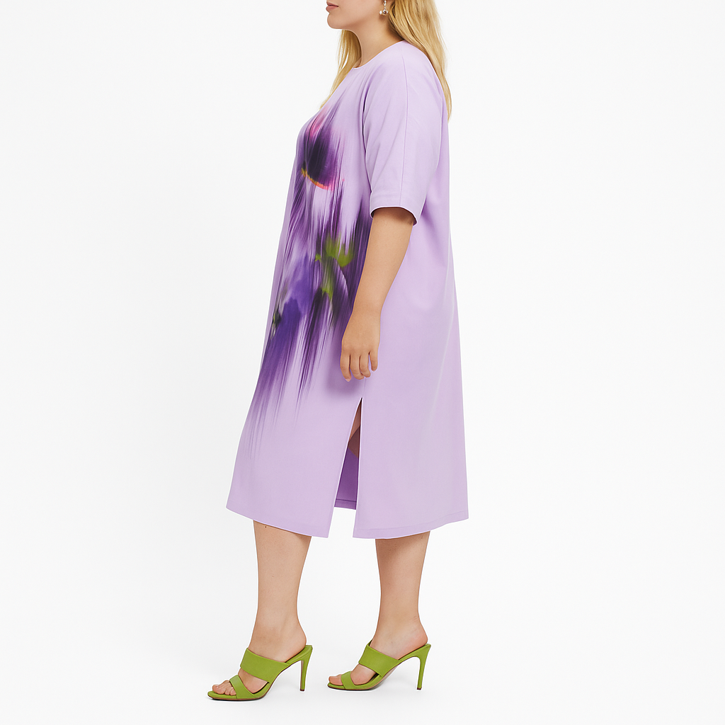 Woman wearing a purple dress with floral design on a white background