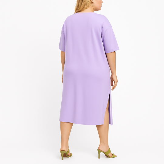 Woman wearing a light purple dress with a slit on a white background