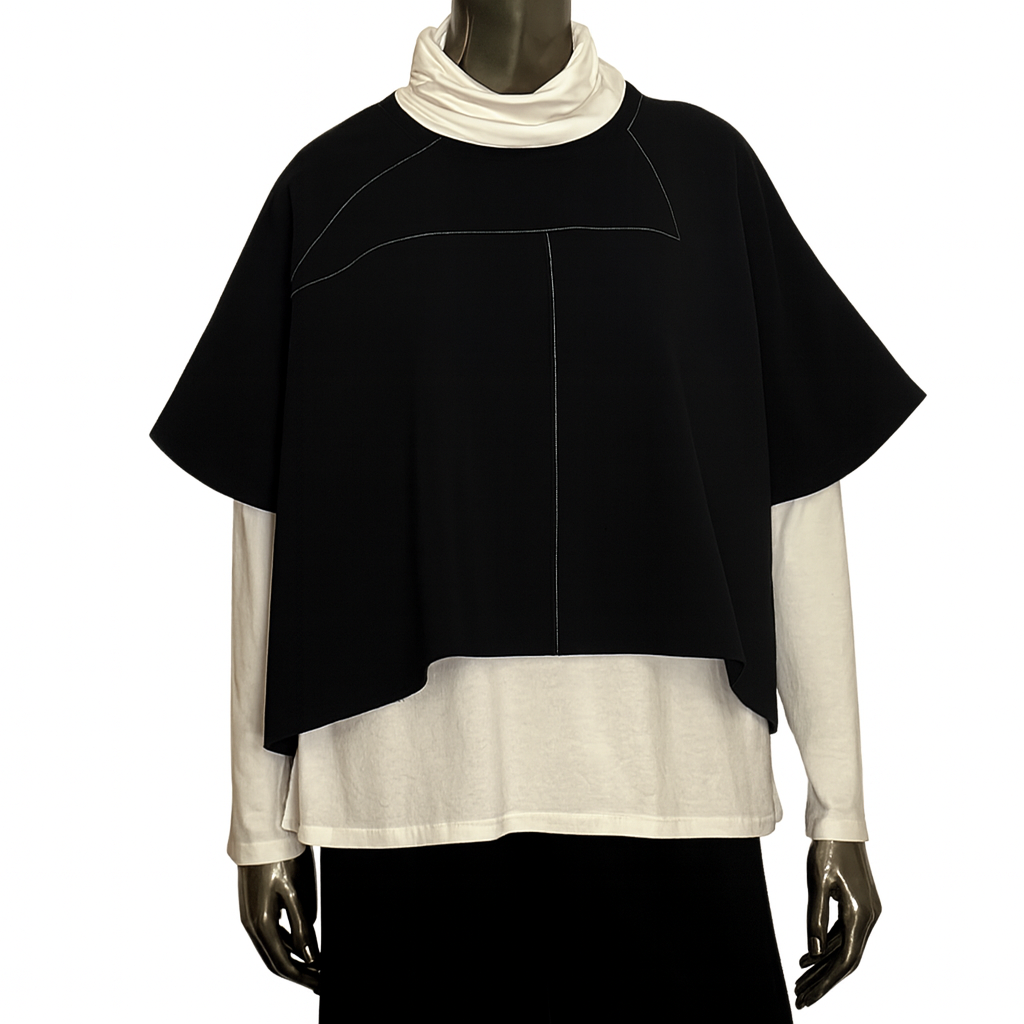 Mannequin wearing a black and white layered outfit on a white background