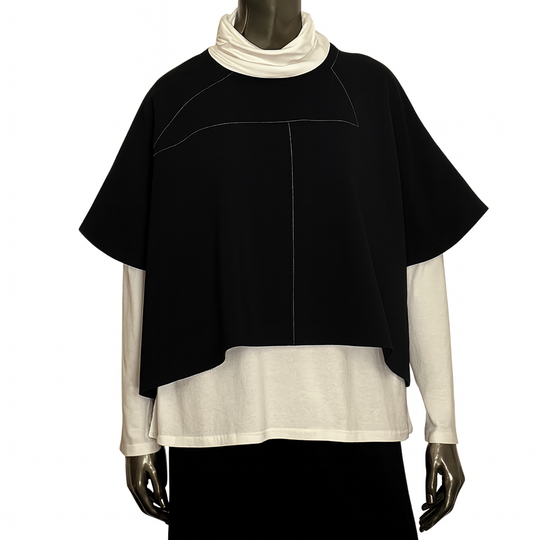 Mannequin wearing a black and white layered outfit on a white background