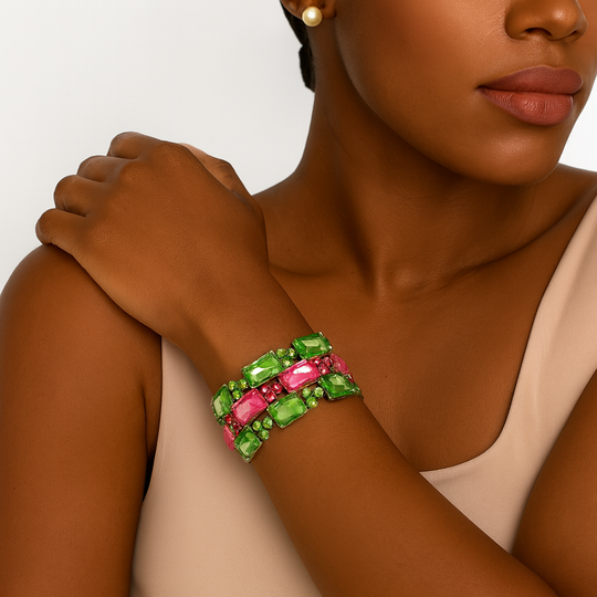 Pink and green rectangular crystal gem cluster bracelet in silver-tone setting, three-row stretch design, photographed on model wearing neutral dress – Le’ Diva Boutique.
