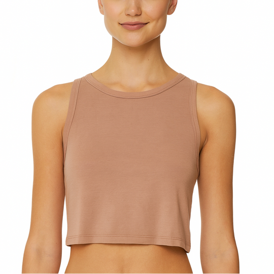 Woman wearing a beige tank top on a white background