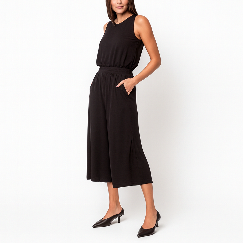 Woman wearing a black sleeveless dress on a white background