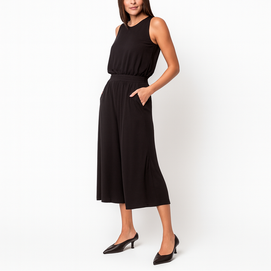 Woman wearing a black sleeveless dress on a white background