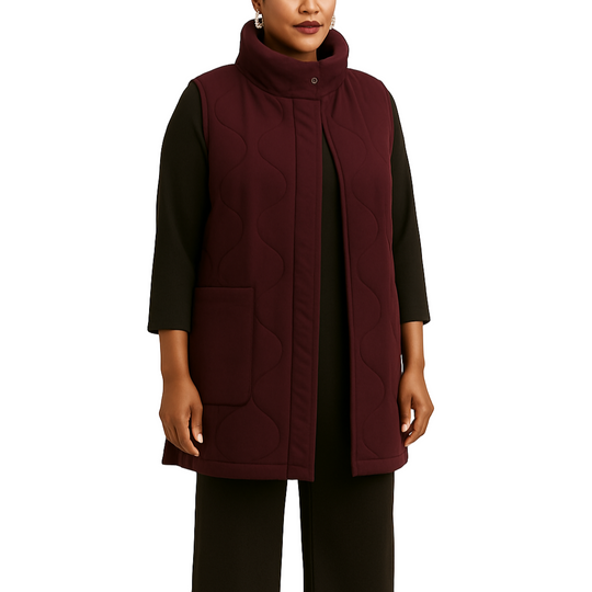 Woman wearing a burgundy coat on a white background