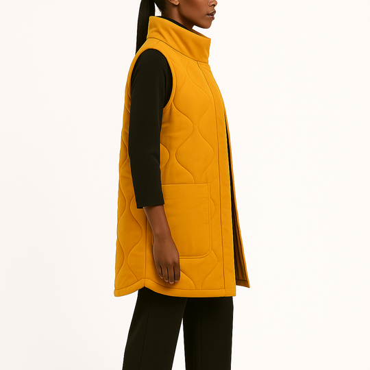 Woman wearing a yellow quilted vest on a white background