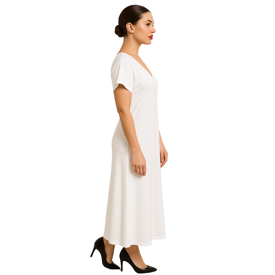 Woman wearing a white dress against a beige background