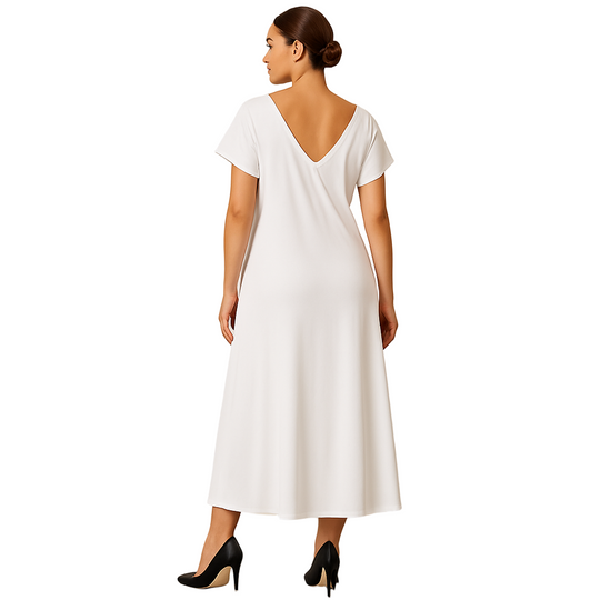 Woman wearing a white dress with a plain background