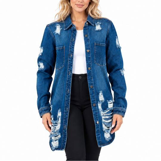 A woman modeling a distressed blue denim shirt jacket over a white top and black pants, photographed against a plain white studio background.