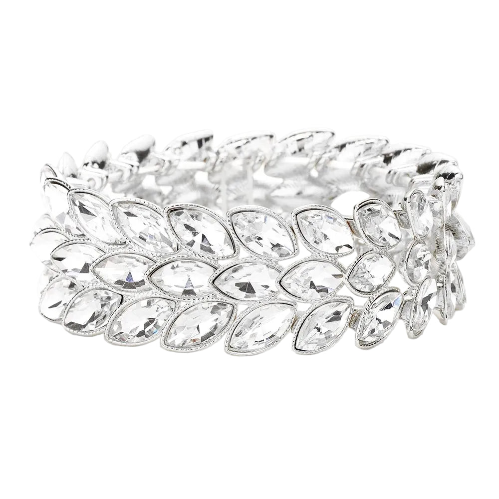 Silver bracelet with leaf-like design and clear stones on a white background