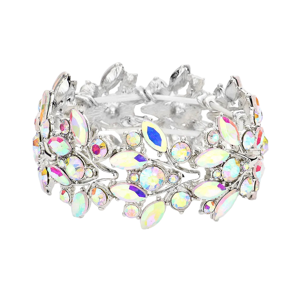 A wide silver-tone cuff bracelet adorned with iridescent rhinestones and marquise-shaped crystals, photographed on a light gray background.