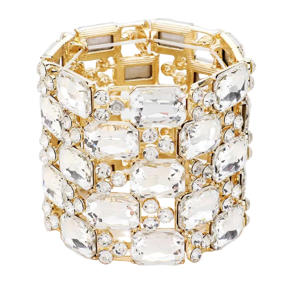 Gold bracelet with clear gemstones on a white background