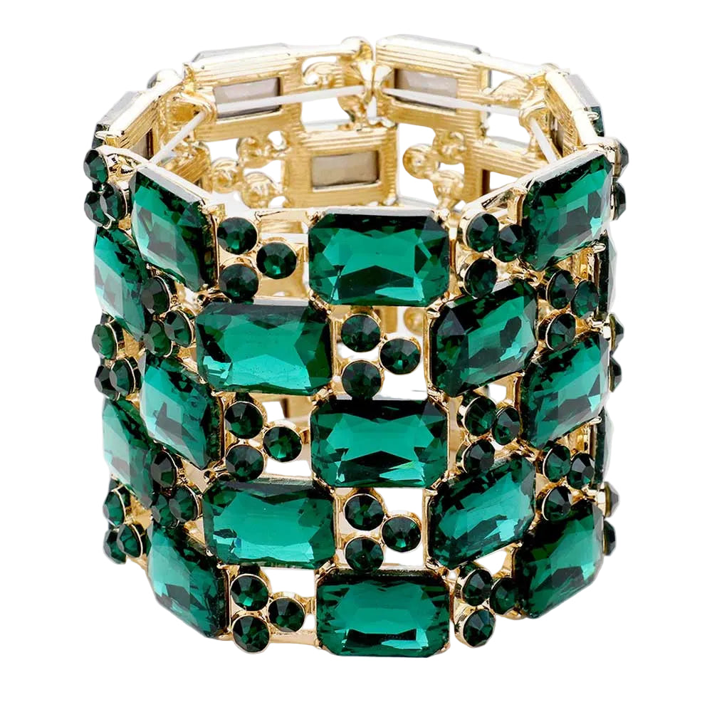 Gold bracelet with green gemstones on a white background