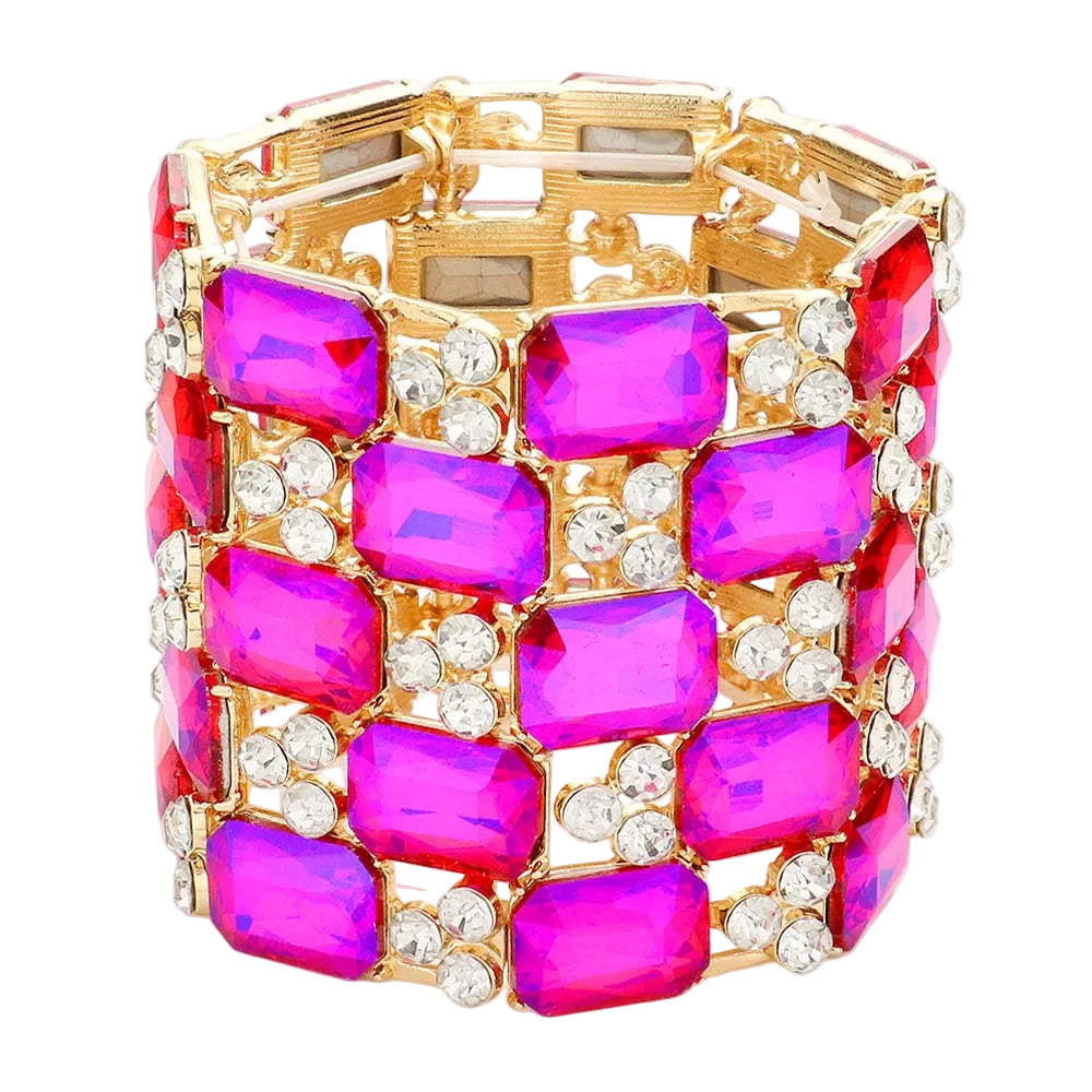Gold bracelet with pink gemstones on a white background