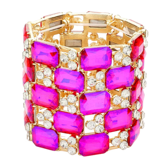 Gold bracelet with pink gemstones on a white background