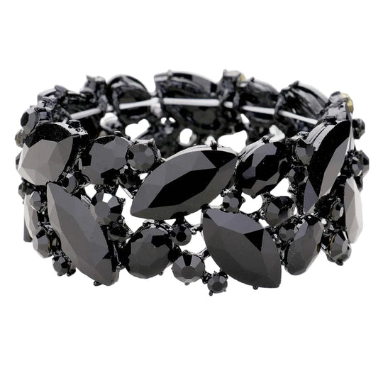 A black gemstone bracelet featuring marquise and round faceted stones in a clustered setting, photographed on a light gray background.