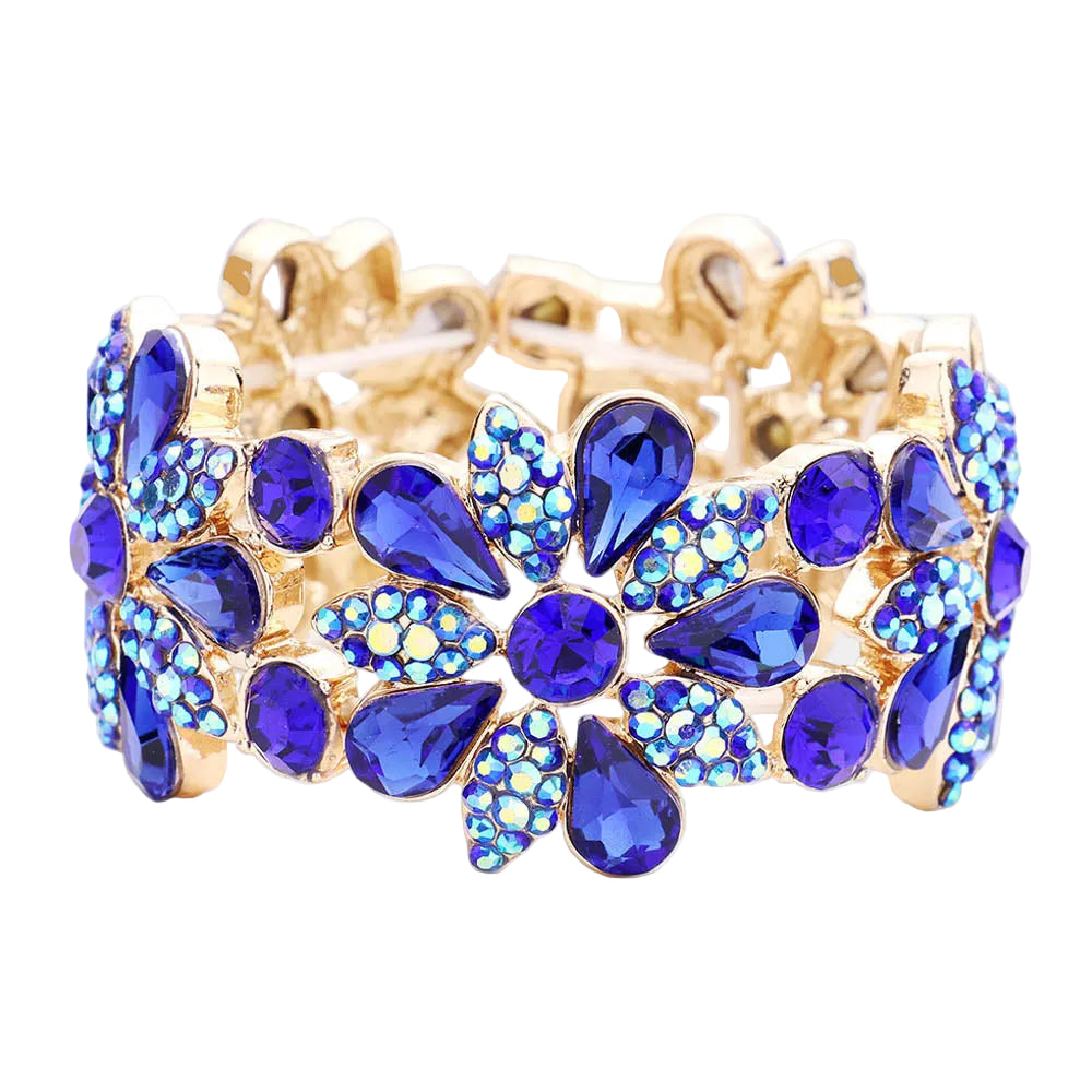 Gold bracelet with blue gemstones on a white background