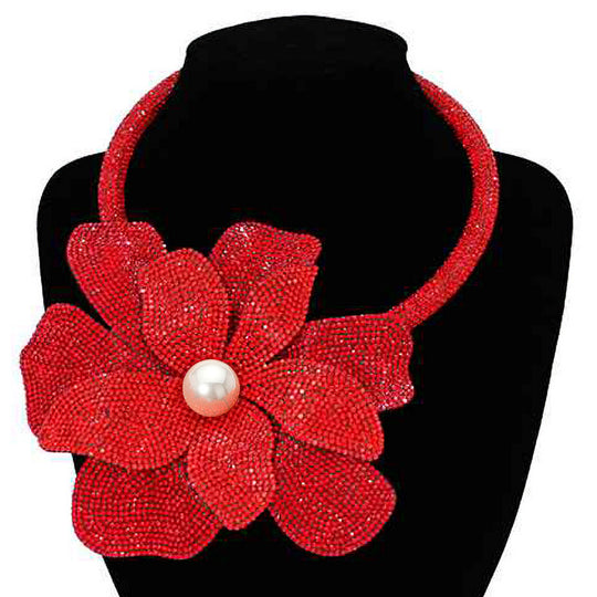 Red floral necklace with a pearl center on a black mannequin.
