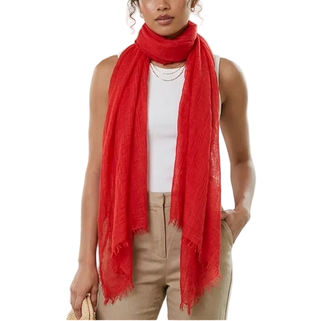 Woman wearing a red scarf in a room with plants