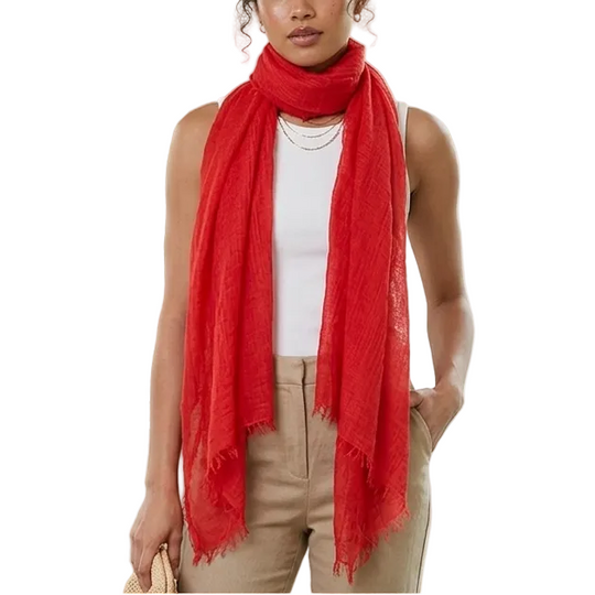 Woman wearing a red scarf in a room with plants