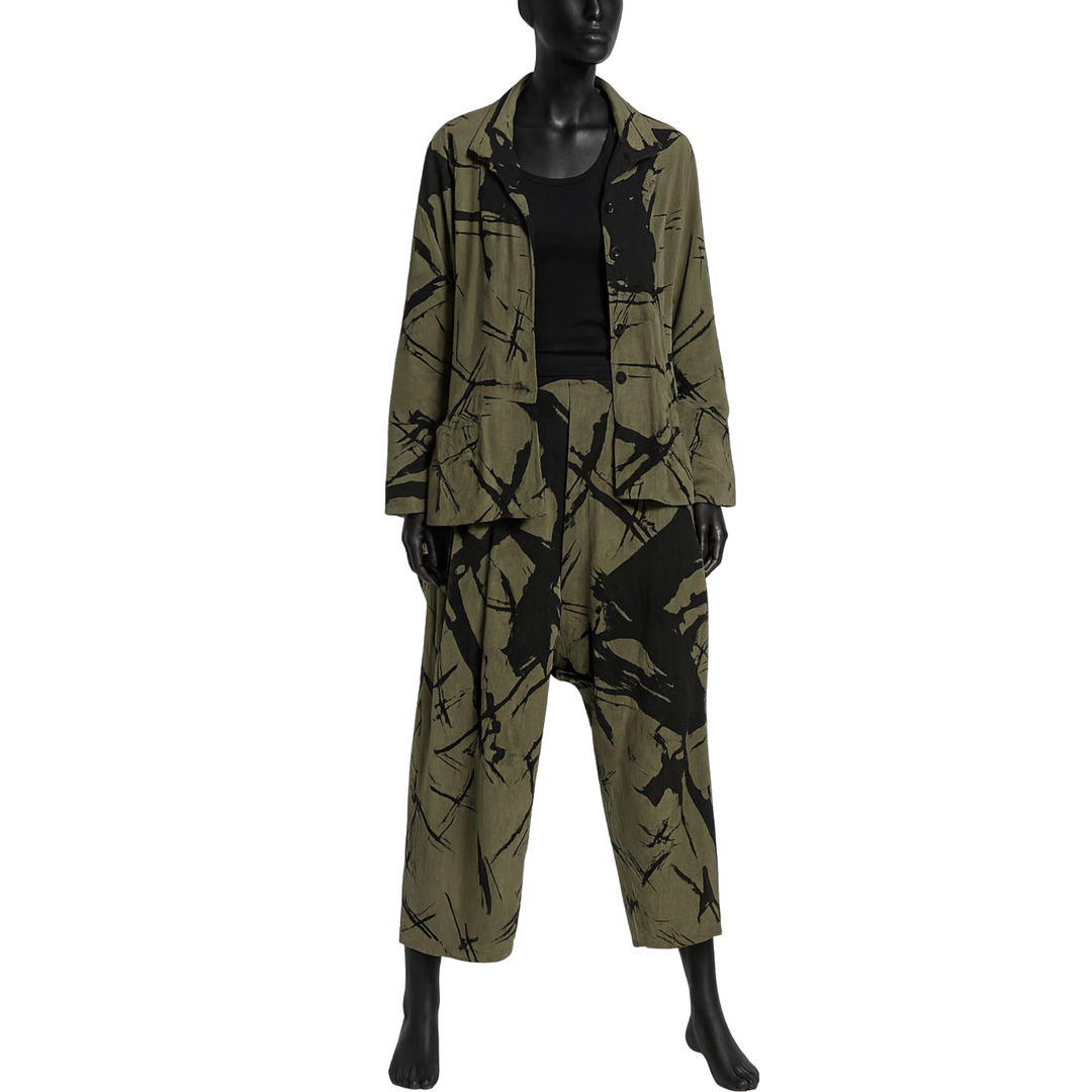 Mannequin wearing a green and black patterned outfit on a white background