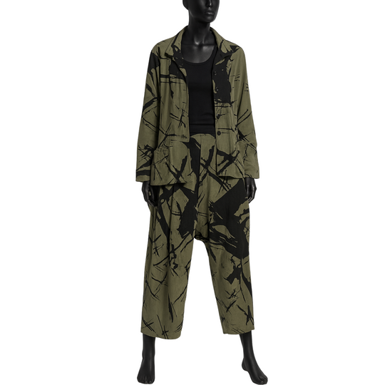 Mannequin wearing a green and black patterned outfit on a white background