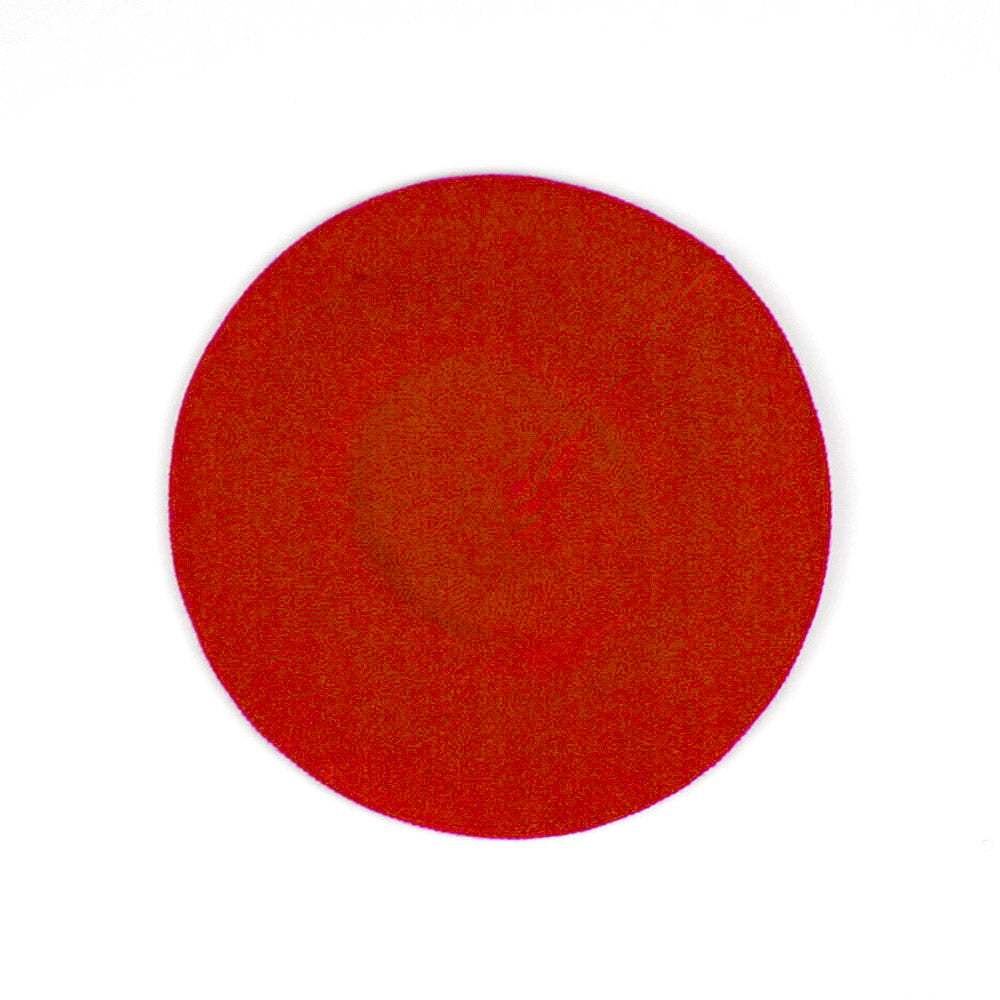 A circular red textured swatch on a plain white background.