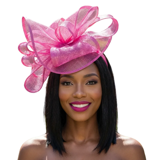 Woman wearing a large pink decorative hat in a garden setting