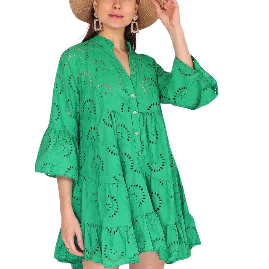 A woman wearing a green embroidered short dress with billowy sleeves, also showing the back of the dress.