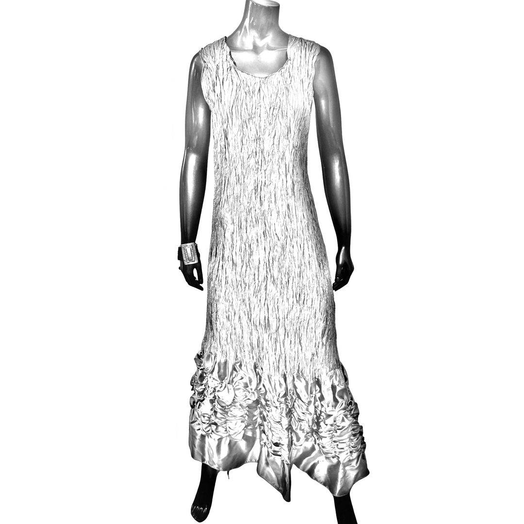 Mannequin wearing a white dress with ruffled details on a white background