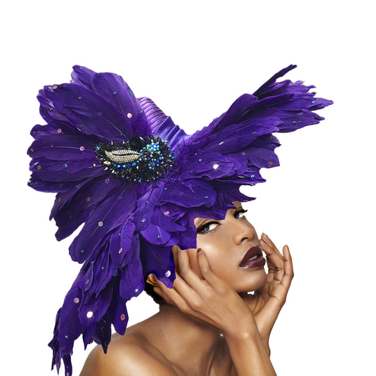 Woman wearing a large purple feathered headpiece on a gray background
