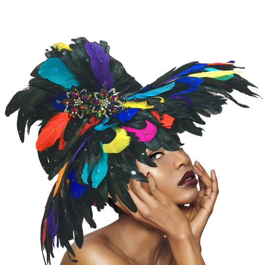 Woman wearing a colorful feather headdress with a plain background