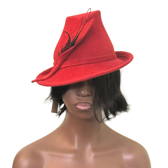 Red hat with decorative bow on a mannequin head against a beige background