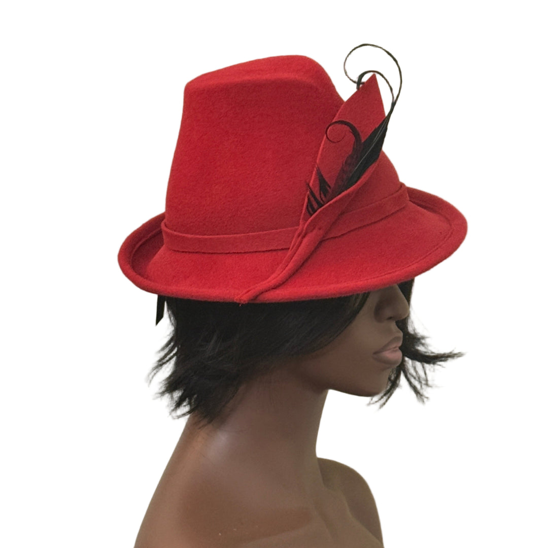 Red hat with a feather on a mannequin head against a beige background