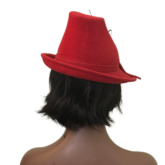 Person wearing a red fedora hat against a plain background