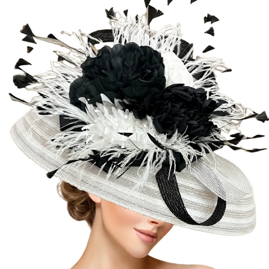 White and black decorative hat with feathers on a blurred natural background