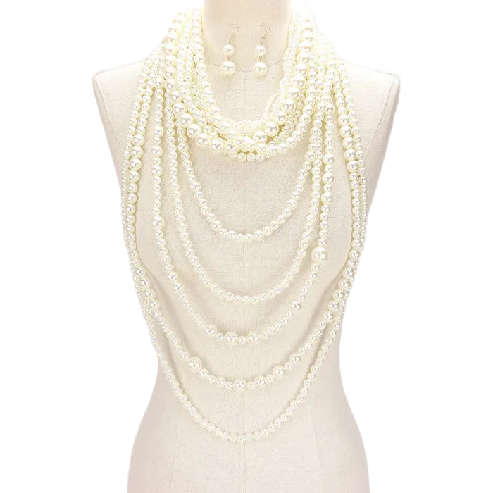Multiple layers of pearl necklaces on a mannequin against a white background