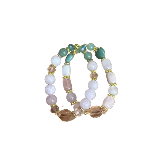 Set of two beaded bracelets on a beige surface