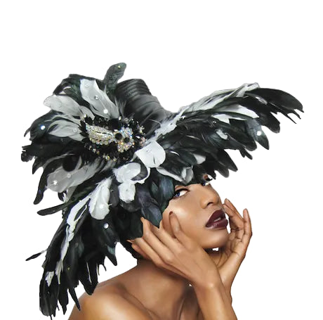 Woman wearing a black and white feathered headdress against a gray background