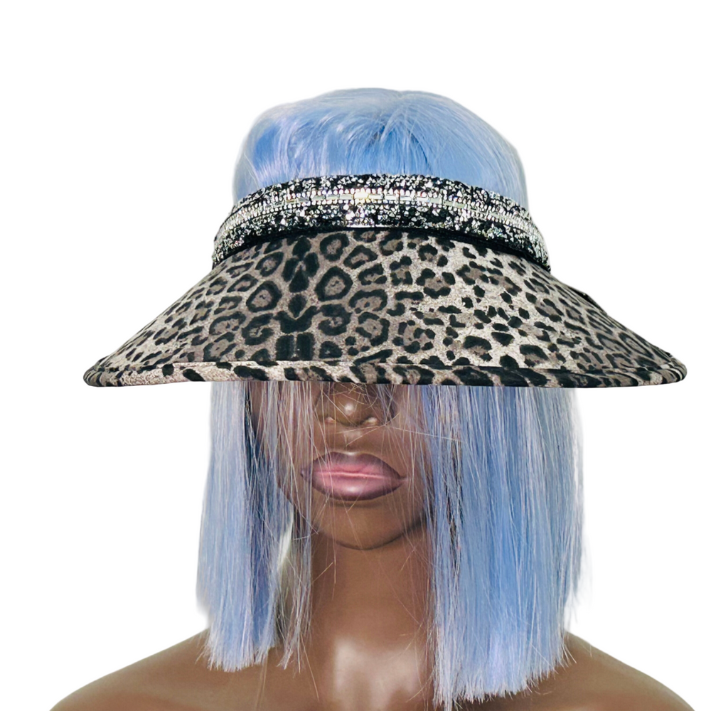 Leopard print visor hat with rhinestone band on a mannequin head with blue hair.